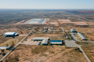Circle 6 Baptist Camp, bottom, and produced water ponds, constructed by Martin Water, top, in Lenorah on Feb. 24, 2024. The Railroad Commission approved the construction of the ponds, used to treat and recycle produced water from fracking, next to the Circle 6 Baptist Camp in the Permian Basin. Credit: Julian Mancha for The Texas Tribune/Inside Climate News