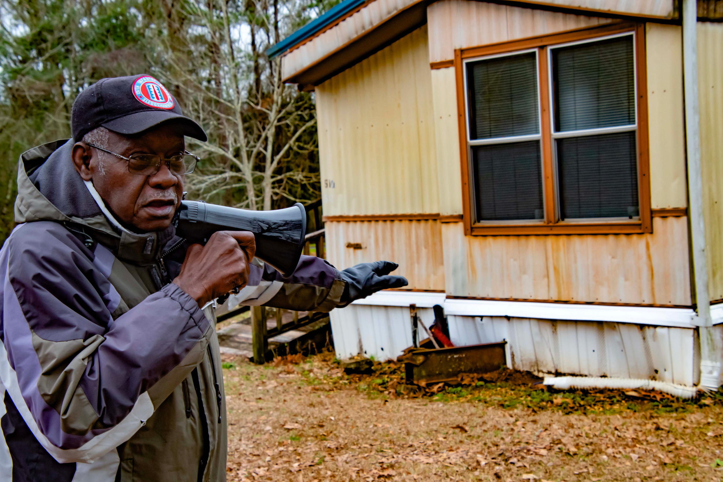 Willie Horstead Jr.'s home is sinking. He describes the situation to those on the community tour. Credit: Lee Hedgepeth/Inside Climate News