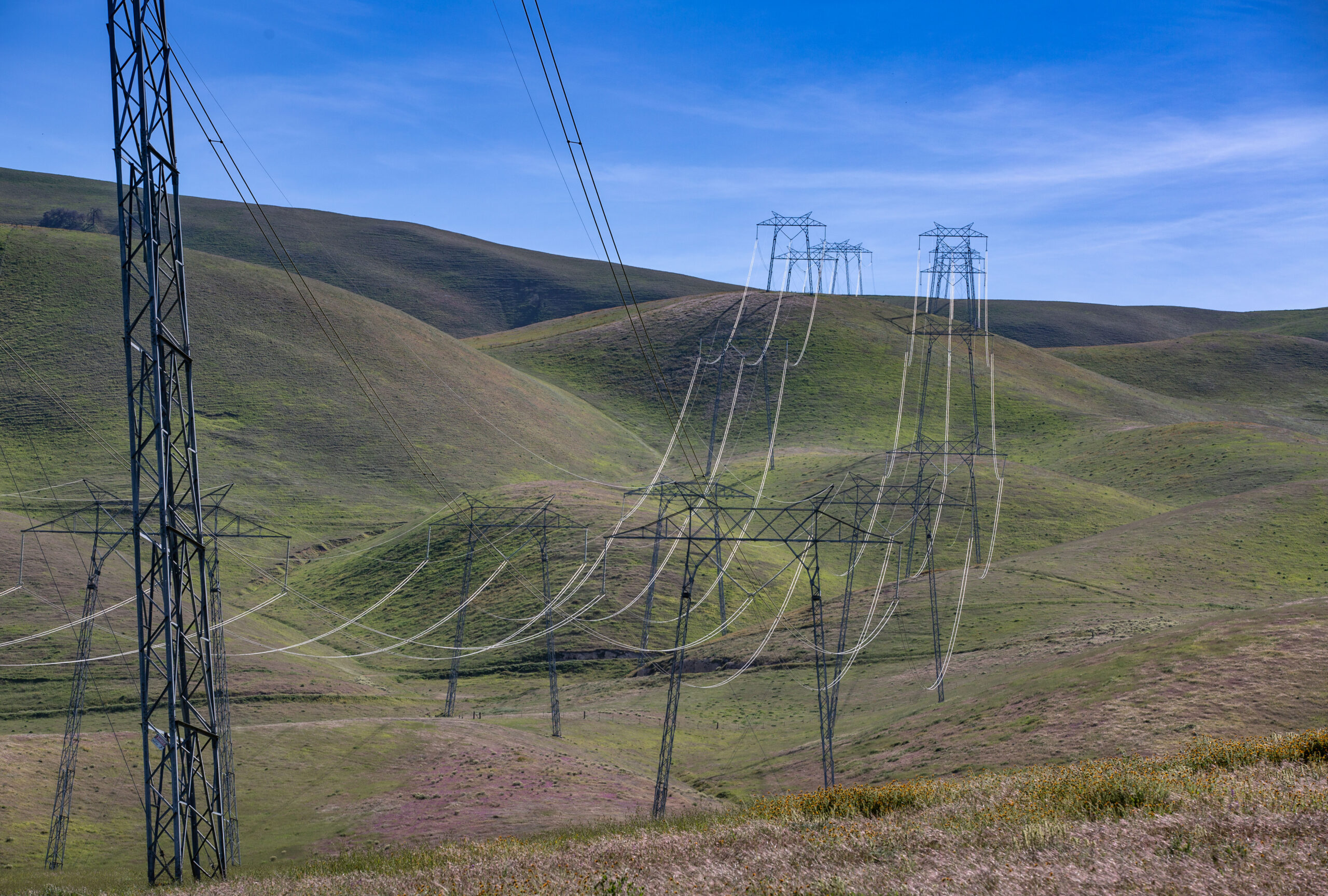 In McKittrick, California, high power electrical transmission lines reach over the mountains from the solar farms in California City to the Central Valley. Credit: George Rose/Getty Images.