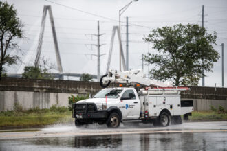 A Dominion Power utility truck drives down a road in Charleston, S.C. Credit: Sean Rayford/Getty Images