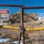 Signs warning of health risks are posted outside the gates of an abandoned uranium mine in the community of Red Water Pond Road, N.M. Credit: The Washington Post via Getty Images