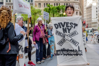 Fossil Free Divest NY, in coordination with community members, rally outside the office of the New York State Comptroller in New York City on May 14, 2018. Credit: Erik McGregor/LightRocket via Getty Images