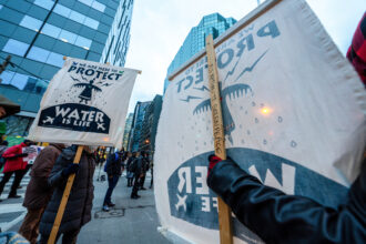 Activists gather outside of the RBC Centre in downtown Toronto in solidarity with Wet’suwet’en land defenders on Dec. 21, 2021. Credit: Katherine Cheng/SOPA Images/LightRocket via Getty Images