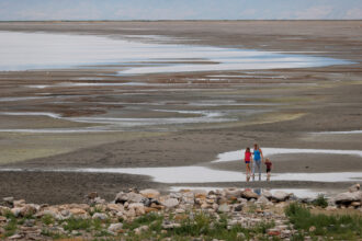State park visitors walk along a section of the Great Salt Lake that used to be underwater on Aug. 2, 2021 near Magna, Utah. Credit: Justin Sullivan/Getty Images