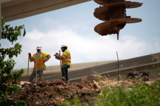 Construction workers rebuild the I-69 Southwest/I-610 West Loop Interchange during a heat wave in Houston, Texas, on July 14, 2023. Credit: Mark Felix/AFP via Getty Images