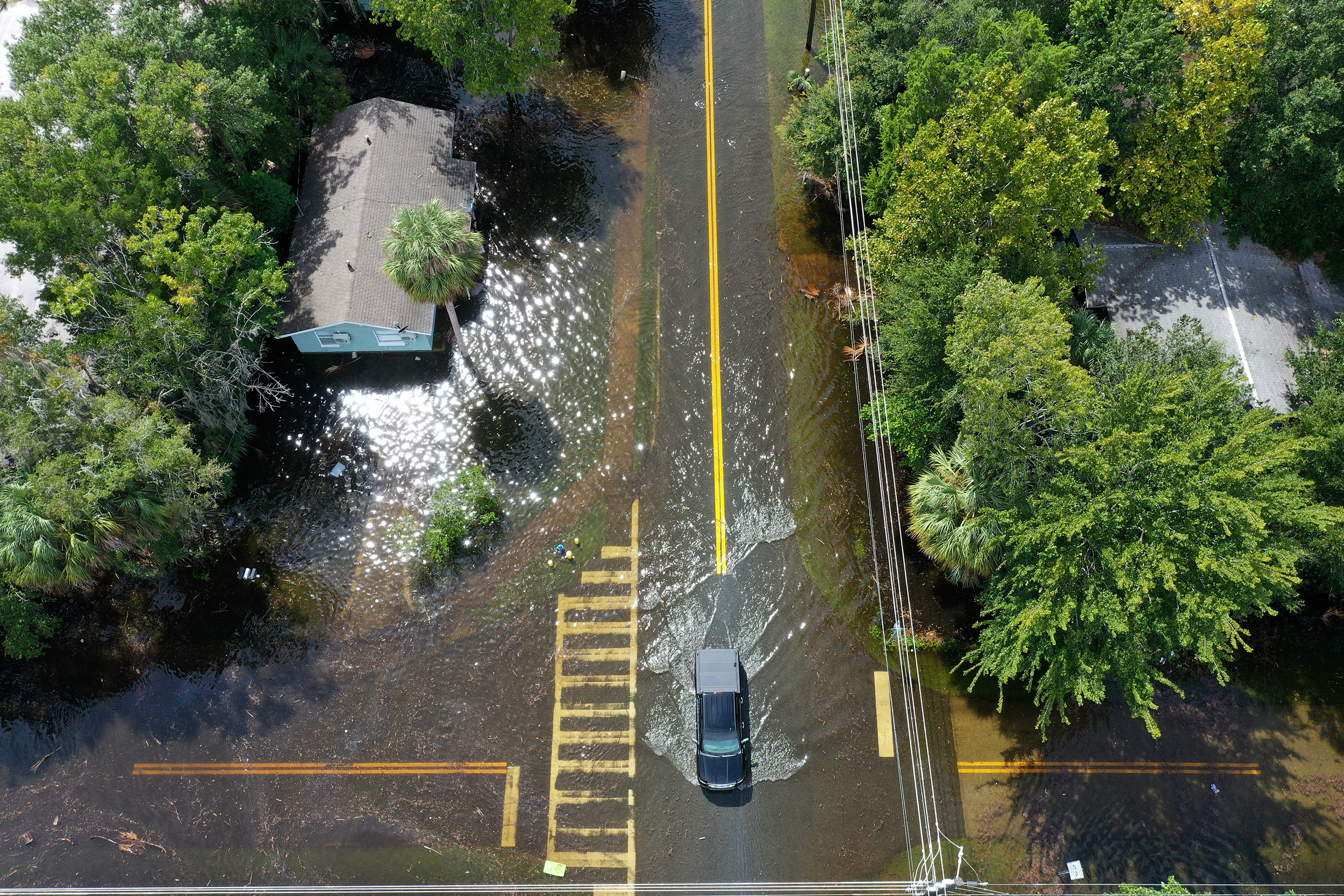 A vehicle drives through a flooded street after Hurricane Idalia passed offshore on Aug. 30, 2023 in Crystal River, Fla. Credit: Joe Raedle/Getty Images