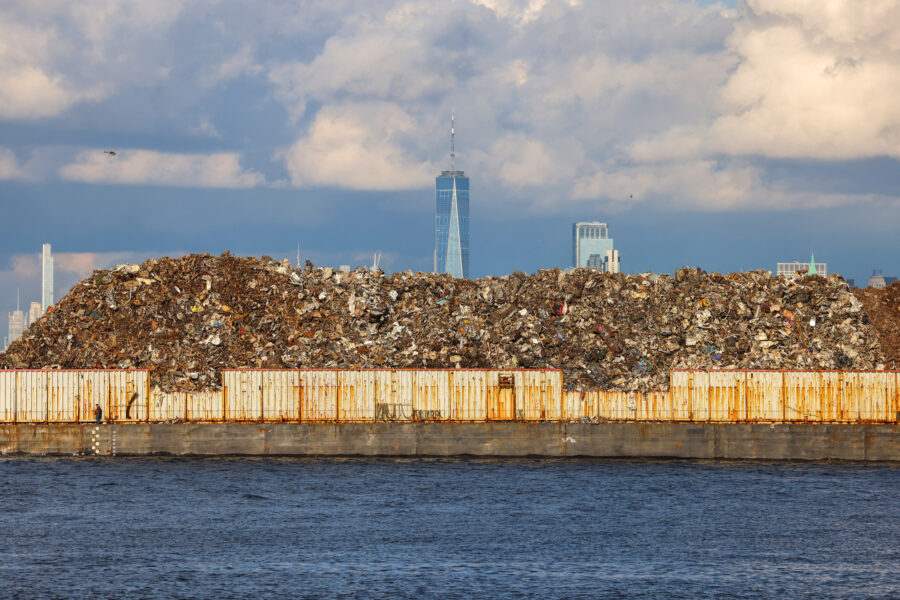 A boat transporting recycling waste sails on the Upper New York Bay between Staten Island and Manhattan on Dec 29, 2023. Credit: Charly Triballeau/AFP via Getty Images