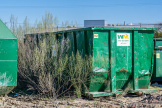 A Waste Management dumpster is seen at the company's facility on Feb. 12 in Austin, Texas. In 2021, Waste Management sought to expand the Hawthorne Park Landfill in Houston. Credit: Brandon Bell/Getty Images