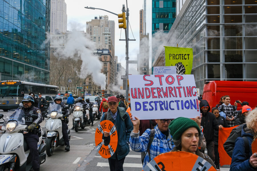 On Feb. 27, About 100 people marched from the New York Public Library’s flagship location in midtown Manhattan to the headquarters of three insurance companies. Credit: Keerti Gopal/Inside Climate News