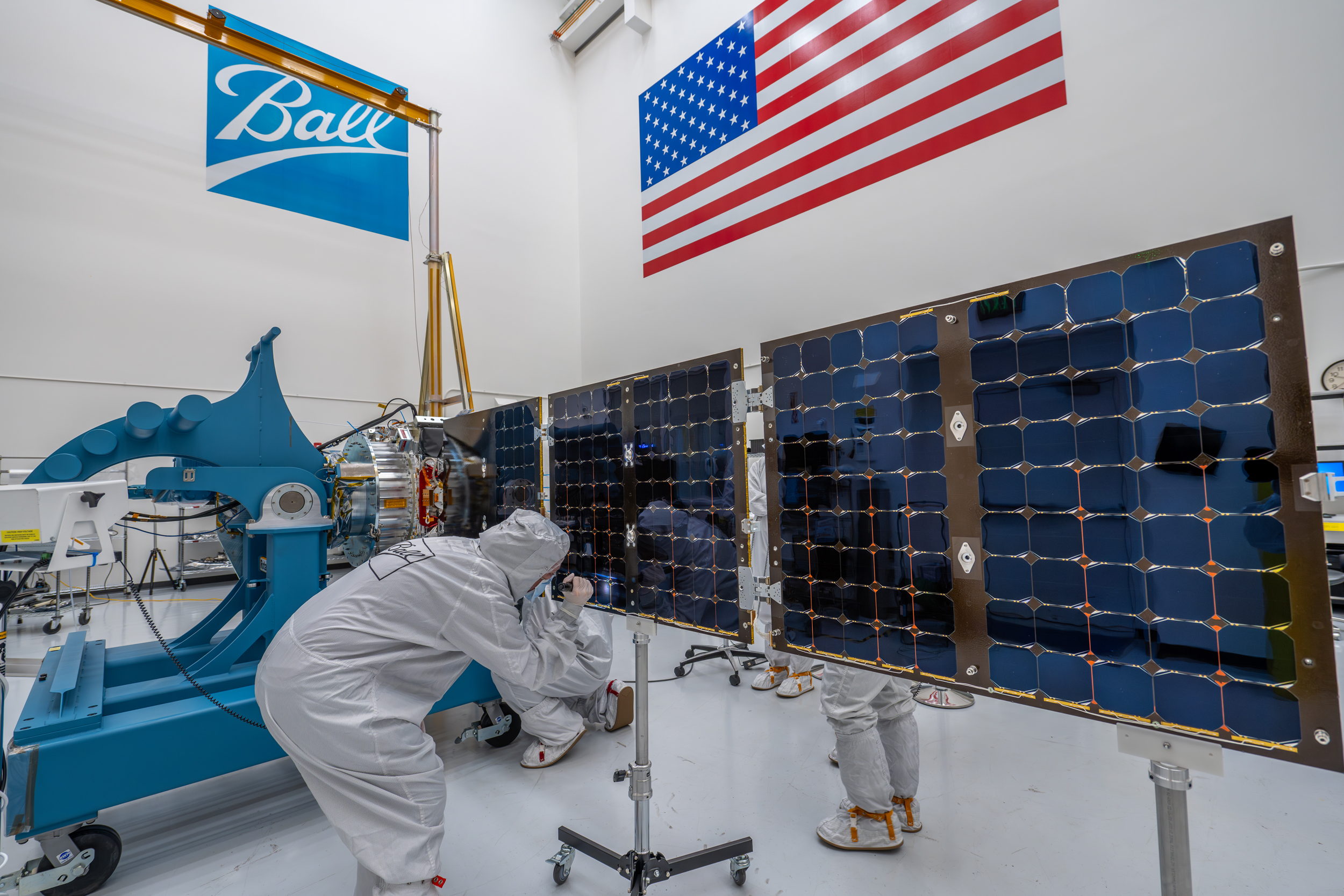 Aerospace engineers reattach MSAT’s solar panels after thermal vacuum (TVAC) testing. Credit: BAE Systems