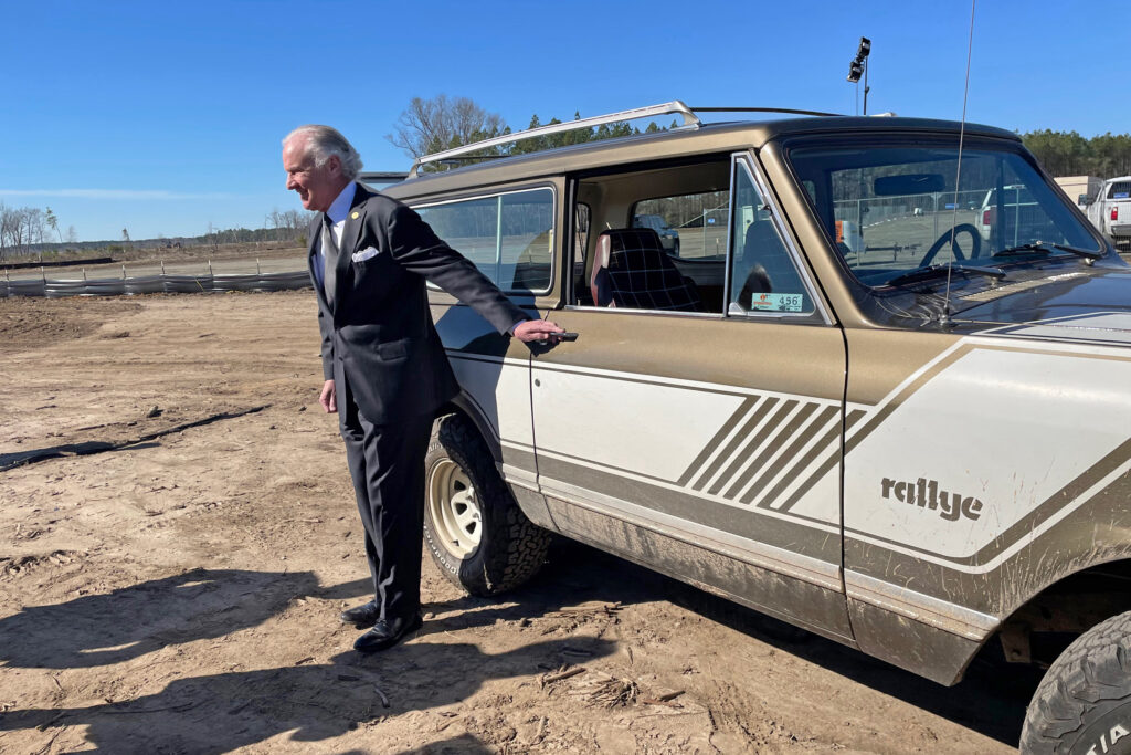 South Carolina Gov. Henry McMaster poses with a vintage Scout. The Republican spearheaded the effort to lure the revived brand's new EV plant to the state by putting together a $1.3 billion incentives package, including new road and rail infrastructure and a job training center. Credit: Marianne Lavelle/Inside Climate News