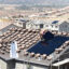 Workers install solar panels on the roofs of homes under construction south of Corona, California on May 3, 2018. Credit: Will Lester/Inland Valley Daily Bulletin via Getty Images
